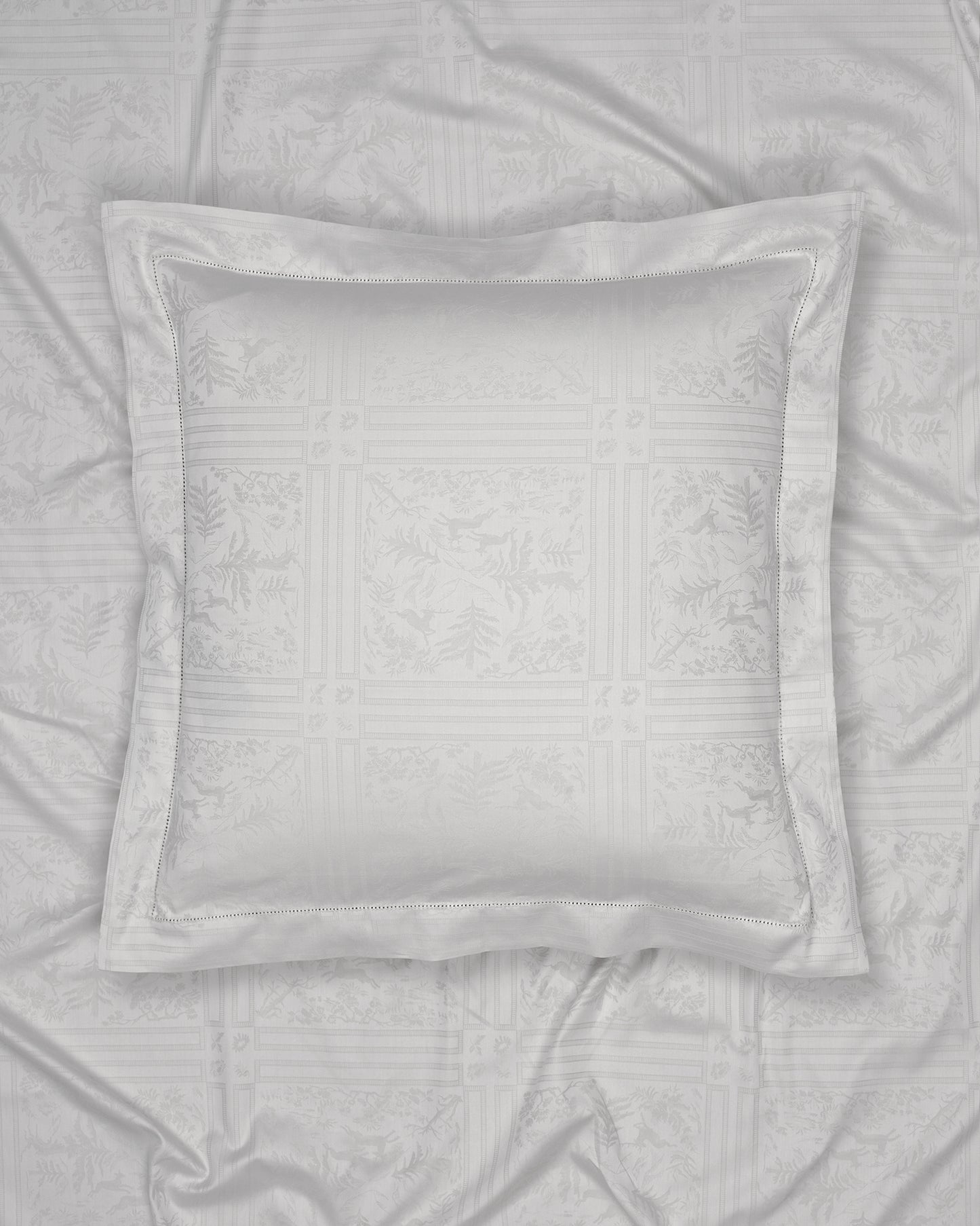 Gray pillow on a textured gray fabric background