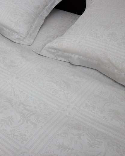 Gray textured bed sheets with folded edges on a black background