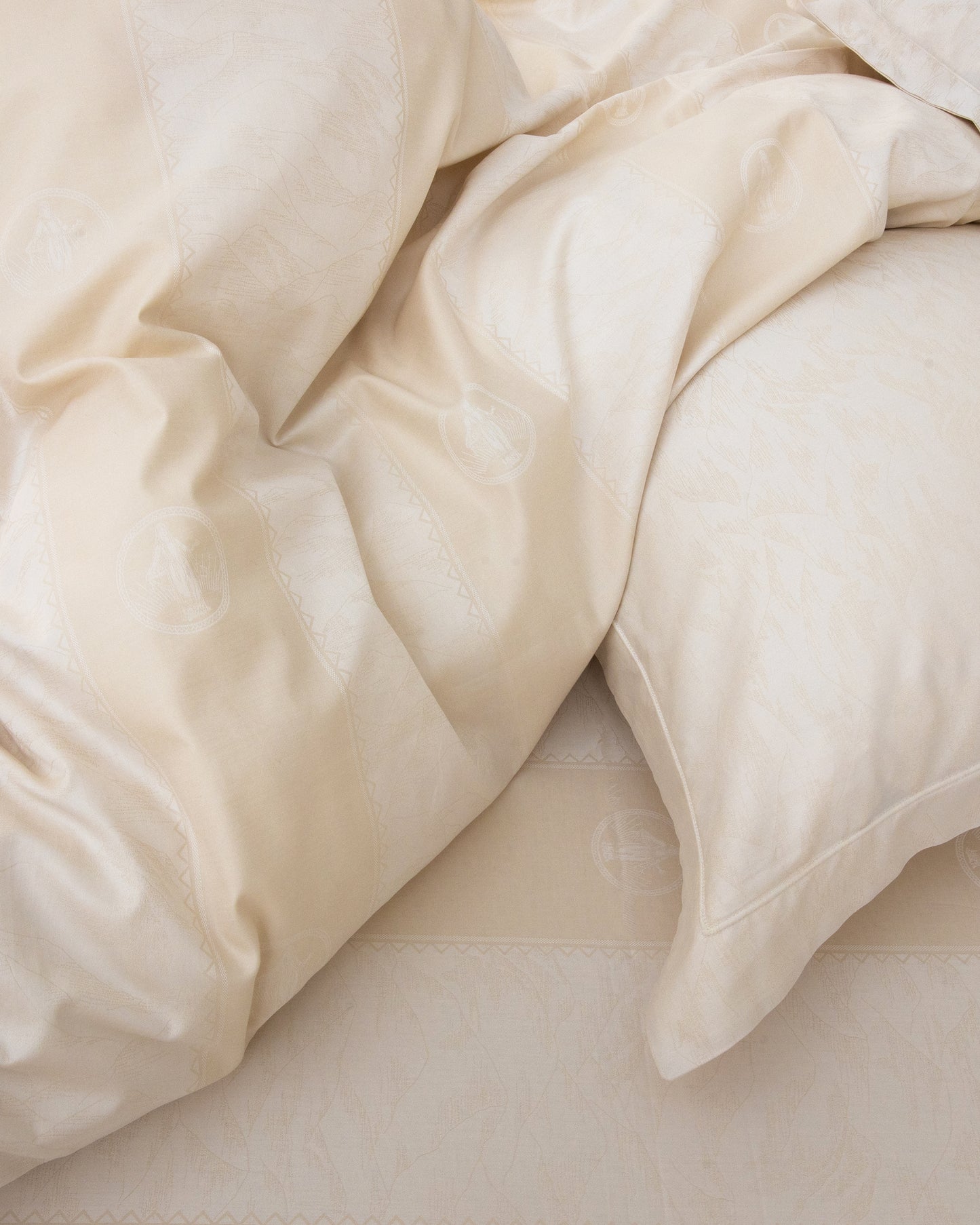 Beige comforter and pillows on a bed